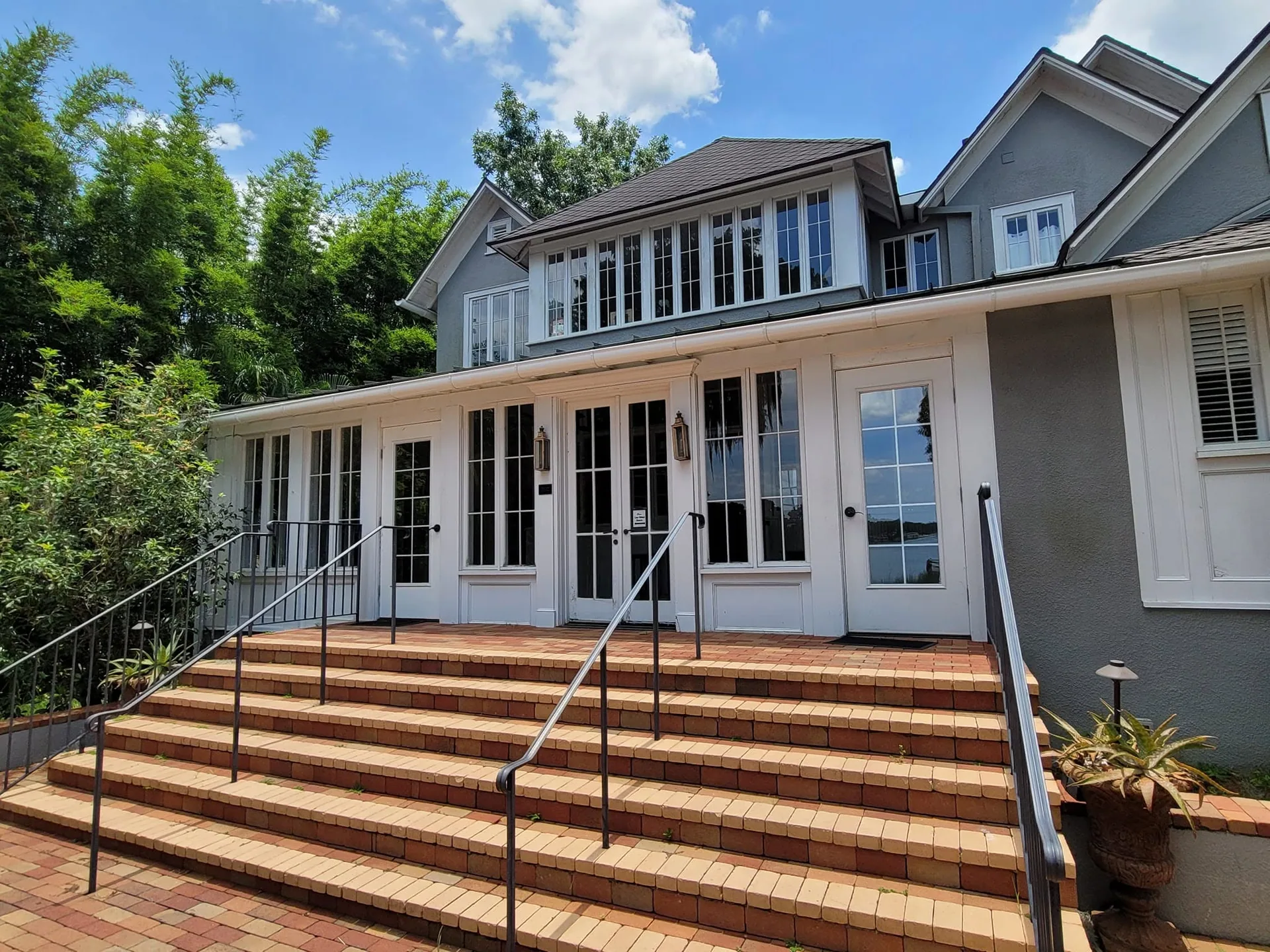 Brick steps gray stucco french doors white gutter fascia, Sanford